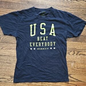 USA Beat Everybody Graphic Tee - Black And Flat Gold Text